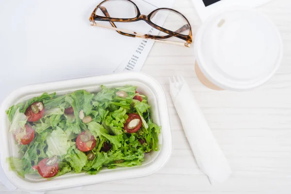 Close up view coffee to go, take away food and eyeglasses on table — Stock Photo
