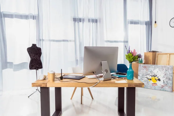 Work place of designer with tailor dummy and computer — Stock Photo