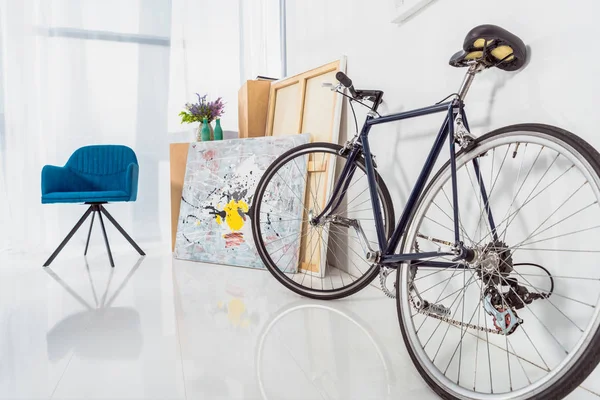 Fahrrad und blauer Stuhl im stilvollen hellen Raum — Stockfoto