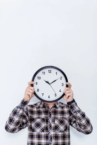 Clock in male hands over his face  isolated on white — Stock Photo