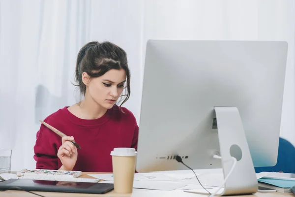 Female artist working with illustrations by computer — Stock Photo