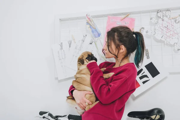 Pretty lady hugging pug by mood board — Stock Photo