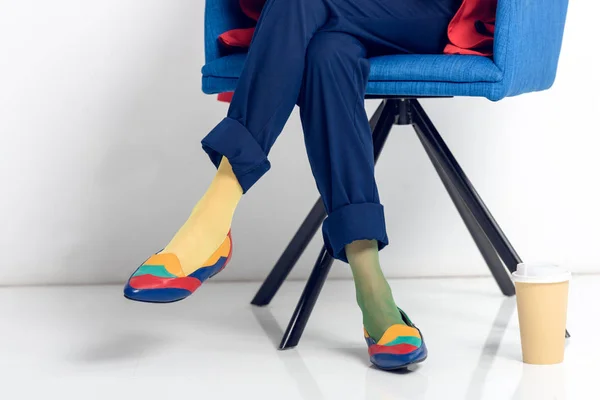 Close-up view of paper cup by female feet — Stock Photo