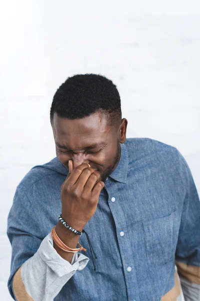 Handsome african american man sneezing — Stock Photo