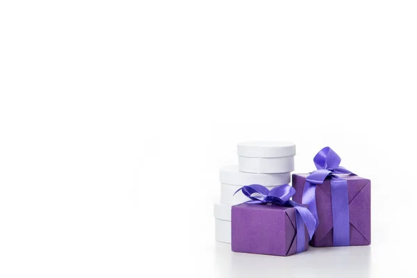 Close up view of arrangement of various wrapped white and purple gifts isolated on white — Stock Photo