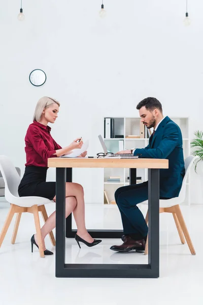 Side view of young business colleagues working together in office — Stock Photo