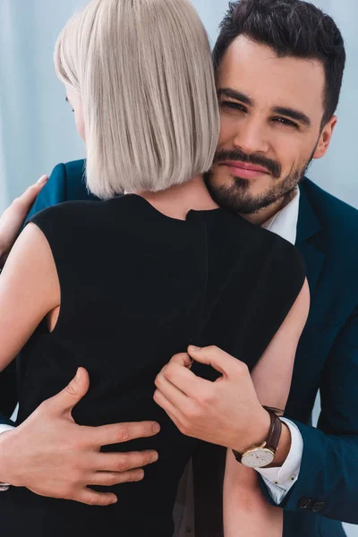 Verführerisches junges Paar umarmt, Mann blickt in die Kamera — Stockfoto