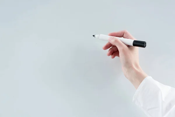 Close-up partial view of buisnesswoman writing on blank whiteboard — Stock Photo