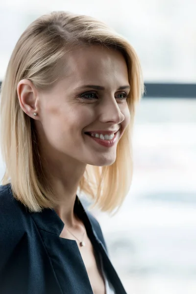 Close-up portrait of beautiful smiling blonde woman looking away — Stock Photo