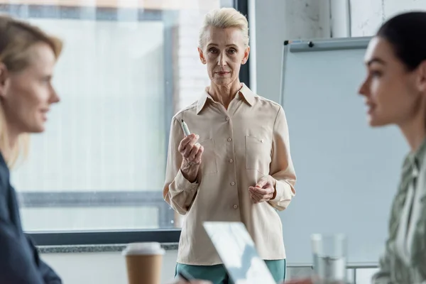 Grey hair businesswoman at meeting in office — Stock Photo