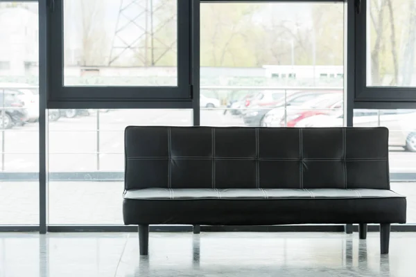 Leather black sofa in empty business office — Stock Photo