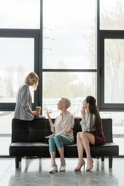 Beautiful businesswomen talking during coffee break in office — Stock Photo