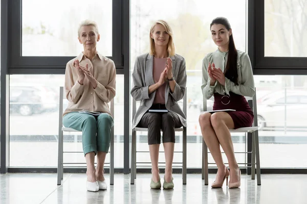 Beautiful three businesswomen applauding in office — Stock Photo