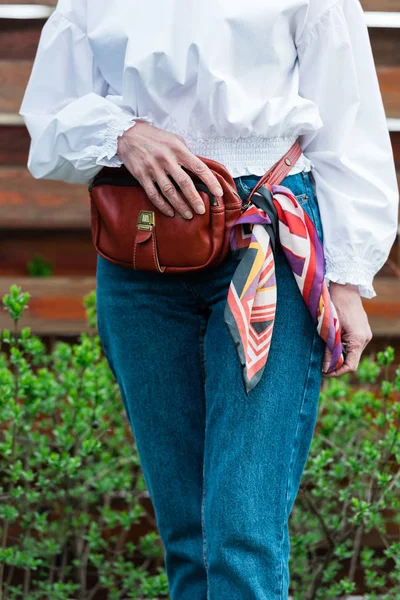 Vue recadrée de la femme à la mode en tenue à la mode avec sac de taille et écharpe — Photo de stock