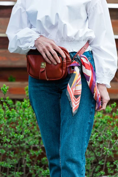 Cropped view of fashionable woman in trendy outfit with waist bag and scarf — Stock Photo