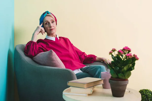 Elegant senior woman relaxing in armchair — Stock Photo