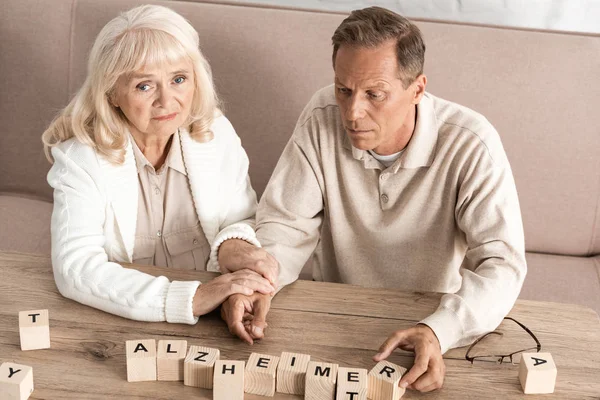 Upset senior woman sitting near husband with dyslexia illness — Stock Photo