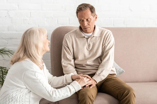 Retired woman looking at husband with dyslexia illness — Stock Photo