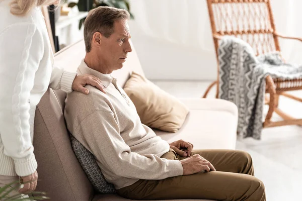 Cropped view of senior woman standing near husband with mental illness — Stock Photo