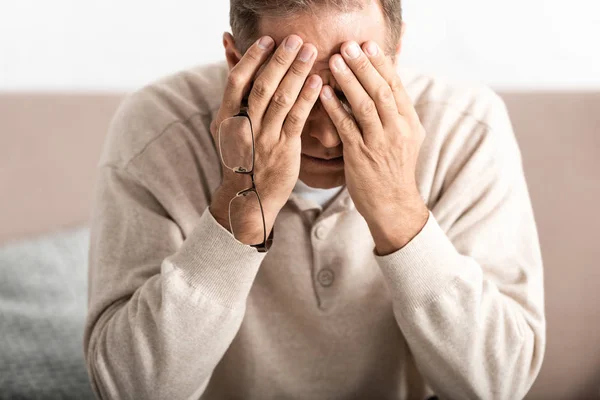 Frustrated senior man with alzheimer disease covering face — Stock Photo