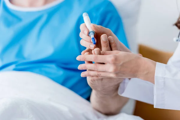 Cropped view of doctor taking blood test from patient in hospital — Stock Photo