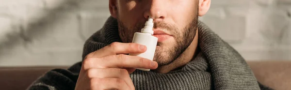 Cropped view of sick man using nasal spray, panoramic shot — Stock Photo