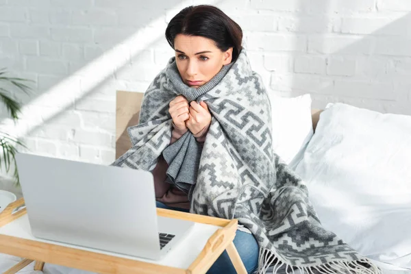 Attractive ill woman having online consultation with doctor on laptop at home — Stock Photo