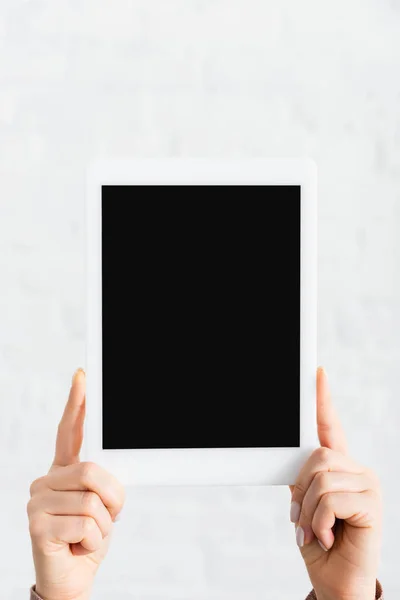 Partial view of woman holding digital tablet with blank screen — Stock Photo