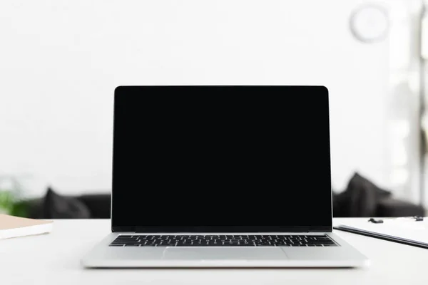 Close up of laptop with blank screen in office — Stock Photo