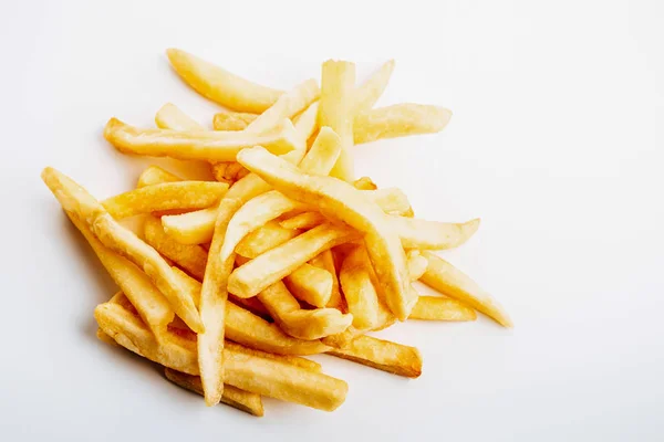 Heap of fresh golden french fries on white background — Stock Photo