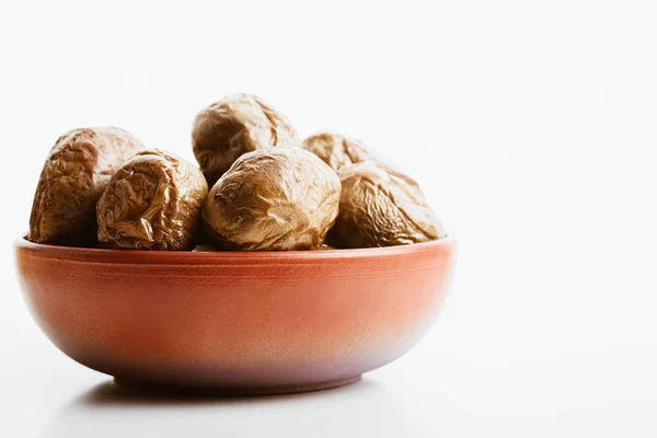 Delicious jacket potato in clay bowl on white background — Stock Photo