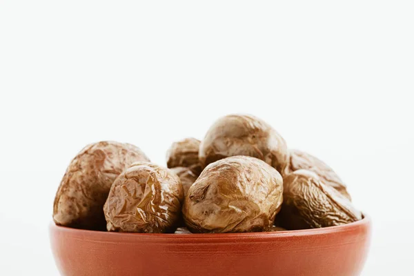 Delicious jacket potato in clay bowl isolated on white — Stock Photo