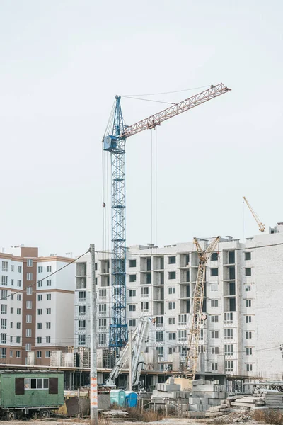 Construction site with cranes and building materials — Stock Photo