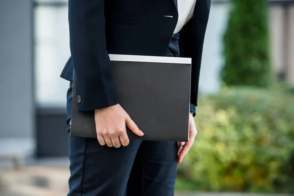 Cropped view of diplomat holding folder and standing outside — Stock Photo