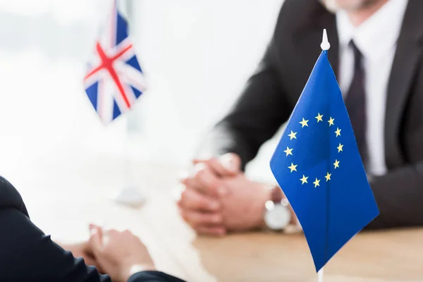 Foyer sélectif du drapeau de l'union européenne près des ambassadeurs avec les mains serrées — Photo de stock