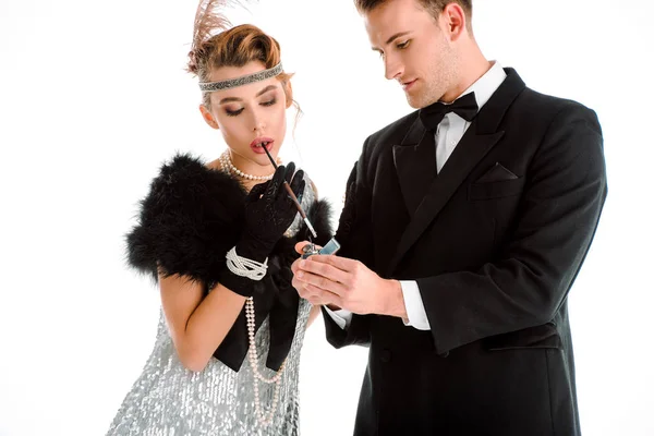 Bel homme tenant plus léger près de femme aristocratique avec cigarette isolée sur blanc — Photo de stock