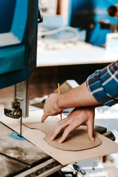 Cropped view of carpenter holding pencil in workshop — Stock Photo