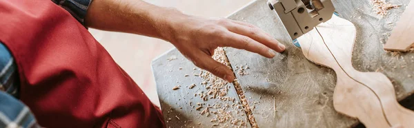 Panoramic shot of carpenter in apron standing near cnc machine — Stock Photo