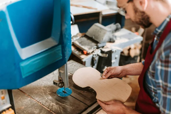 Selective focus of cnc machine near bearded woodworker — Stock Photo