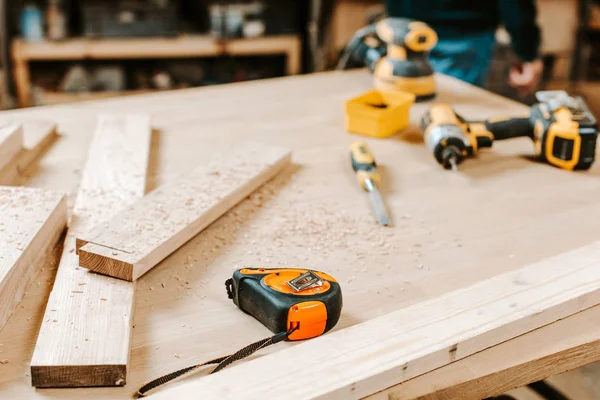 Selective focus of wooden planks near measuring tape on table — Stock Photo