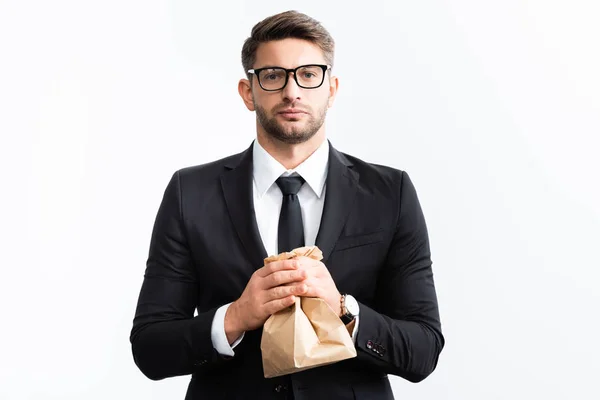 Scared businessman in suit holding paper bag during conference isolated on white — Stock Photo