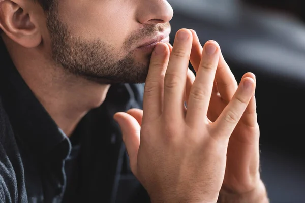 Cropped view of pensive man with clenched hands in apartment — Stock Photo