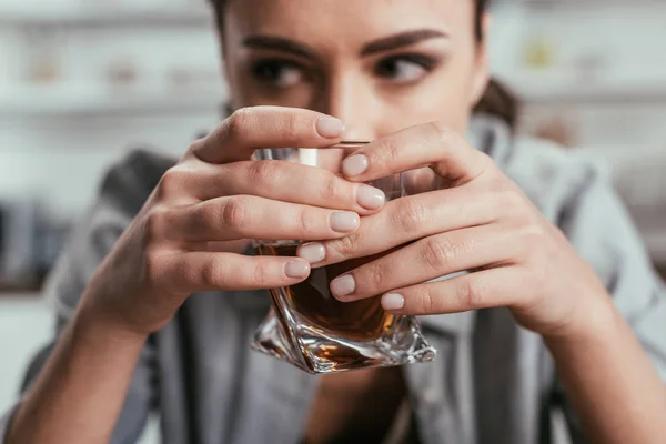 Selective focus of woman holding whiskey glass in hands — Stock Photo