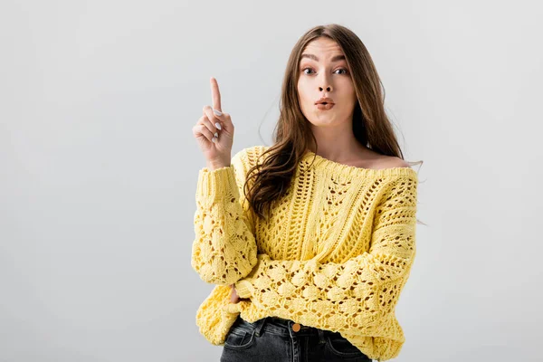 Amazed girl pointing with finger while looking at camera isolated on grey — Stock Photo