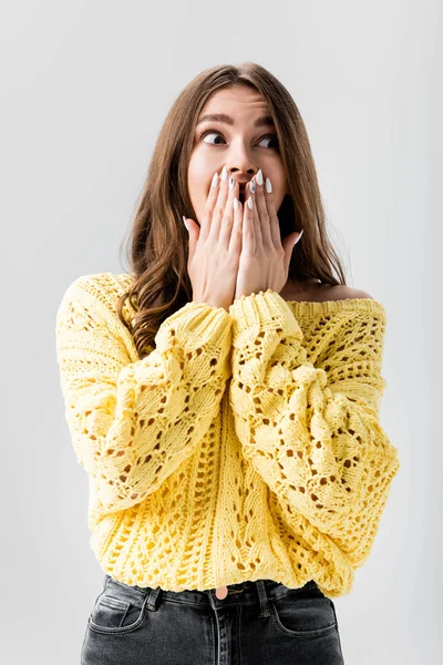 Shocked girl covering mouth with hands and looking away isolated on grey — Stock Photo