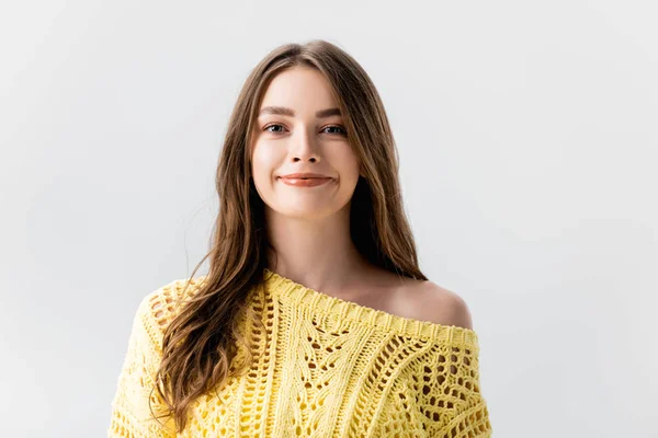 Attractive girl in yellow sweater smiling at camera isolated on grey — Stock Photo