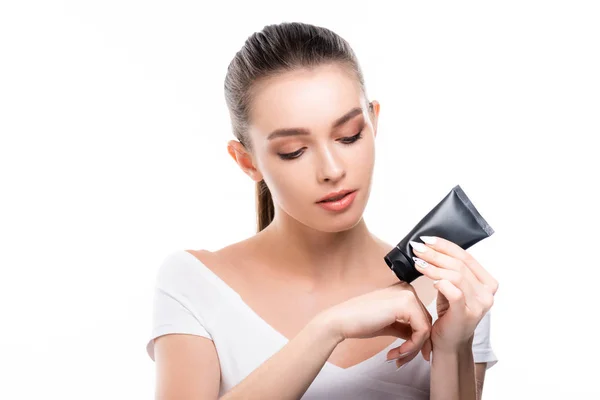 Attractive young woman applying hand cream isolated on white — Stock Photo