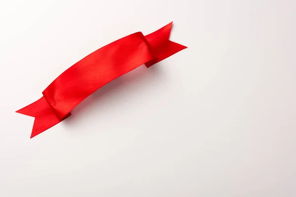 Top view of red satin ribbon on white — Stock Photo