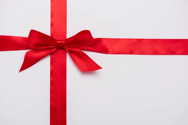 Top view of satin ribbon with red decorative bow isolated on white — Stock Photo