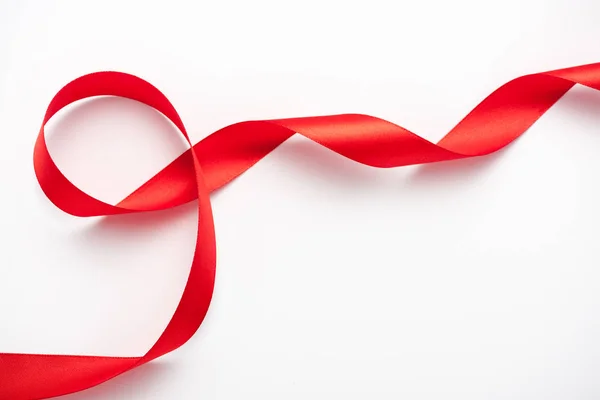 Top view of satin and curled ribbon on white with copy space — Stock Photo